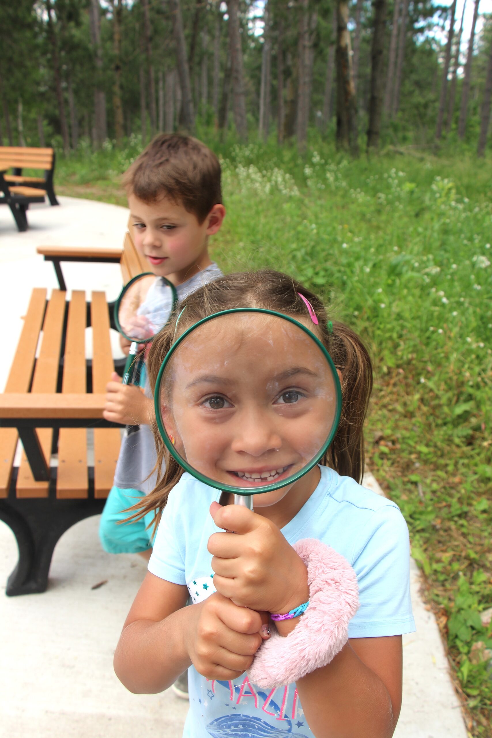 a boy and girl with magnifying glasses