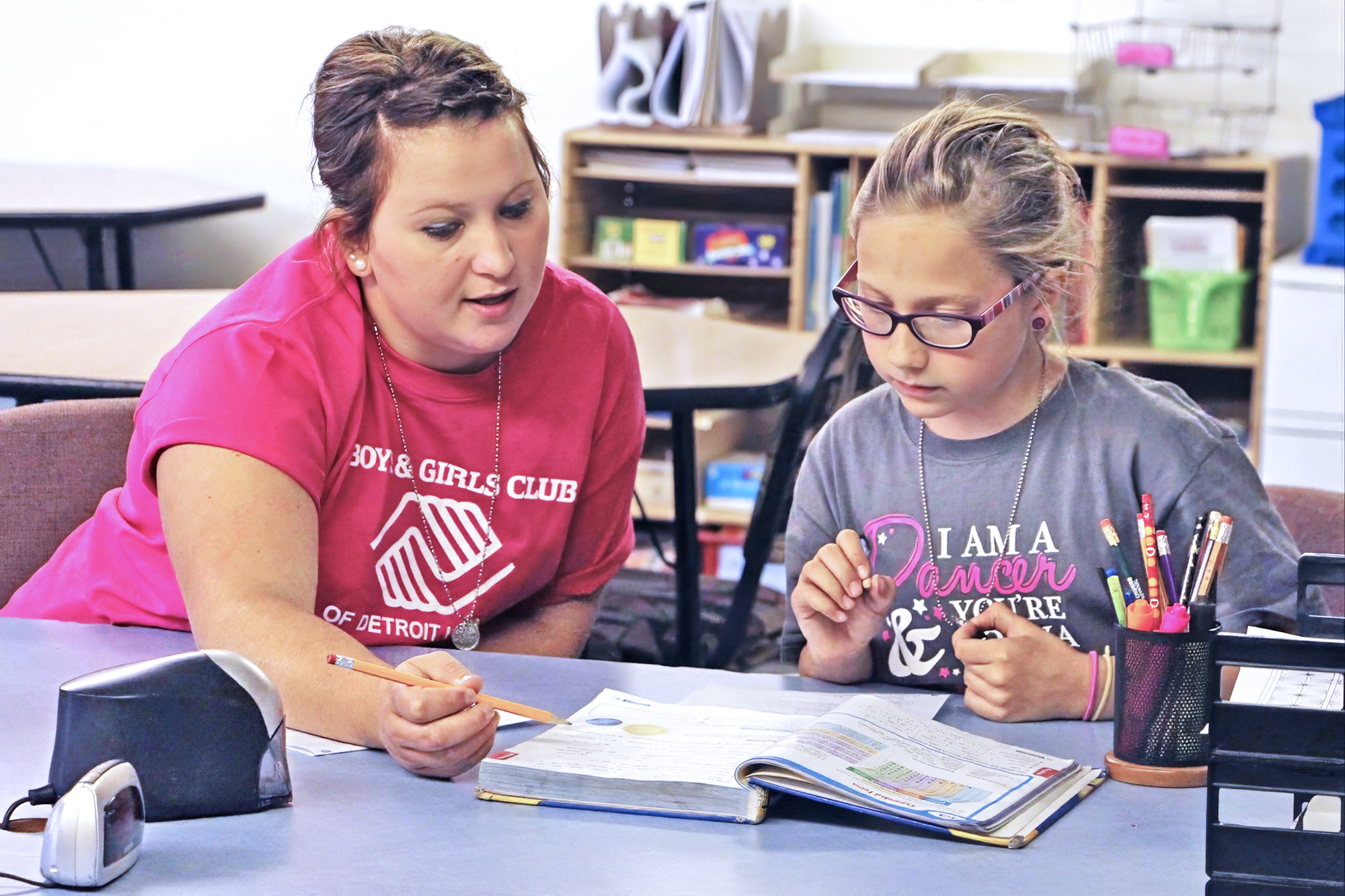 staff member helping a female member with homework