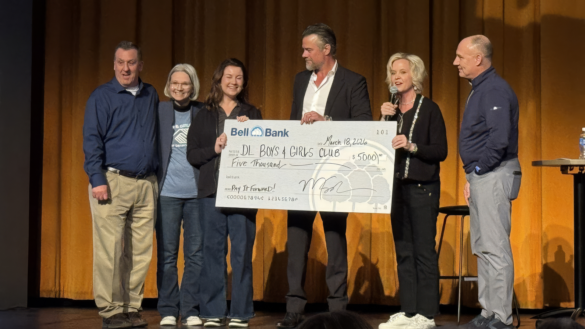 Check presentation to Patrick Petermann and Carrie Johnston from Josh Duhamel and Bell Bank Representives