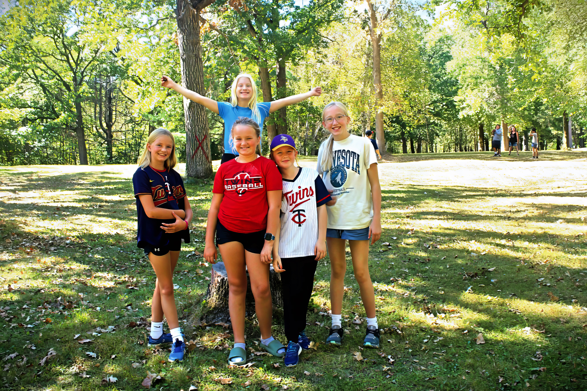 a happy group of girls in a sunny park setting